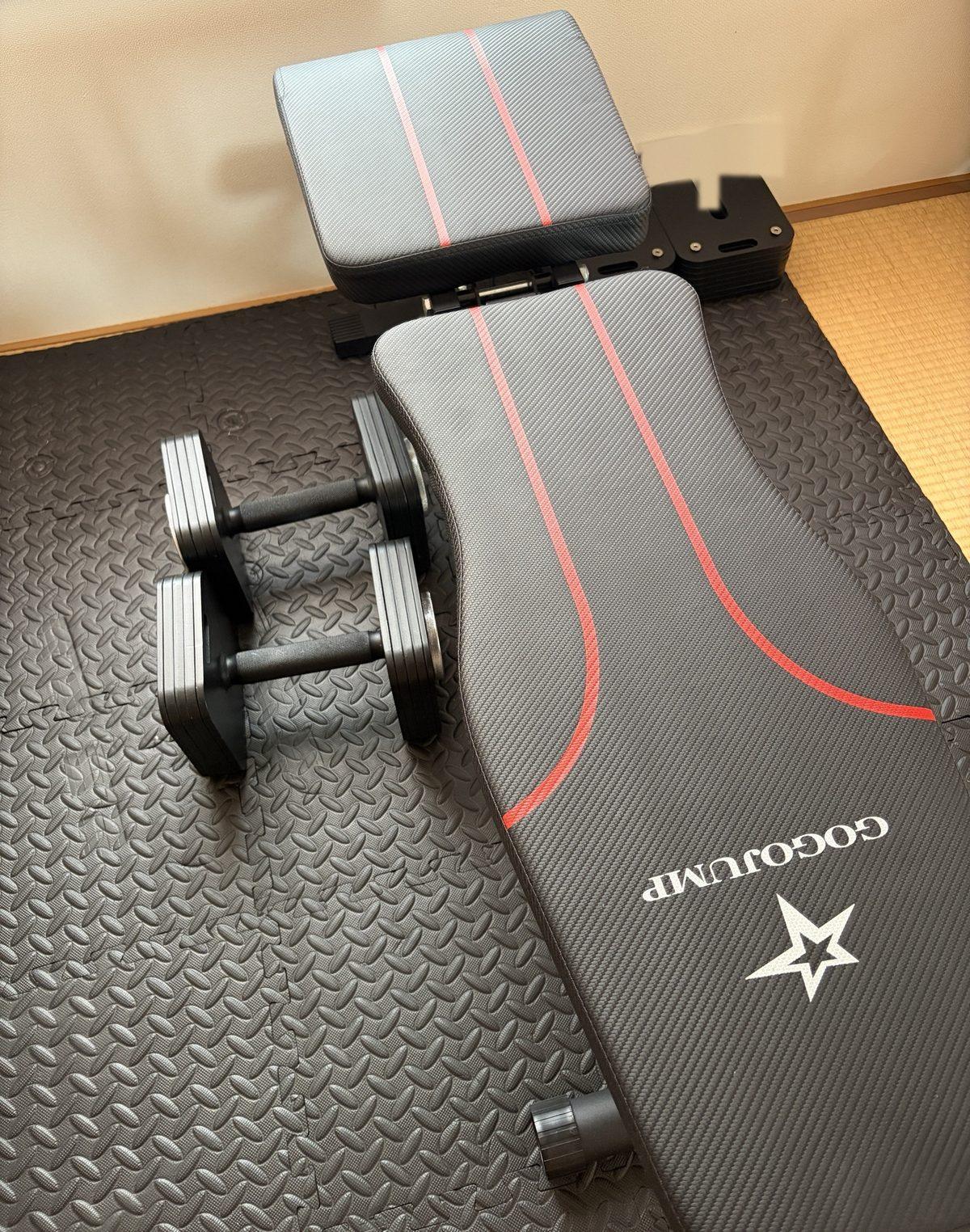 1年使ったGOGOJUMPのトレーニングベンチ。ジョイントマットの上にフラットにして、可変式ダンベルと並べた状態